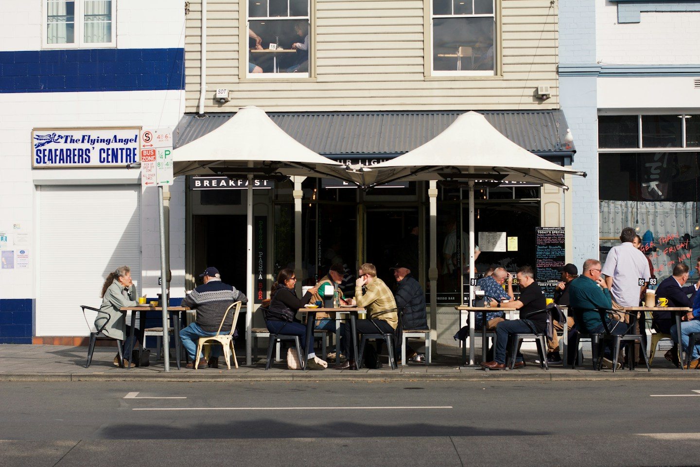Customers seated outside a cafe on an Australian street in Hobart, Tasmania